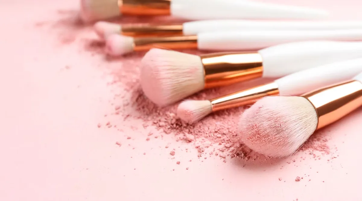 Rose-gold makeup brushes and blush powder
