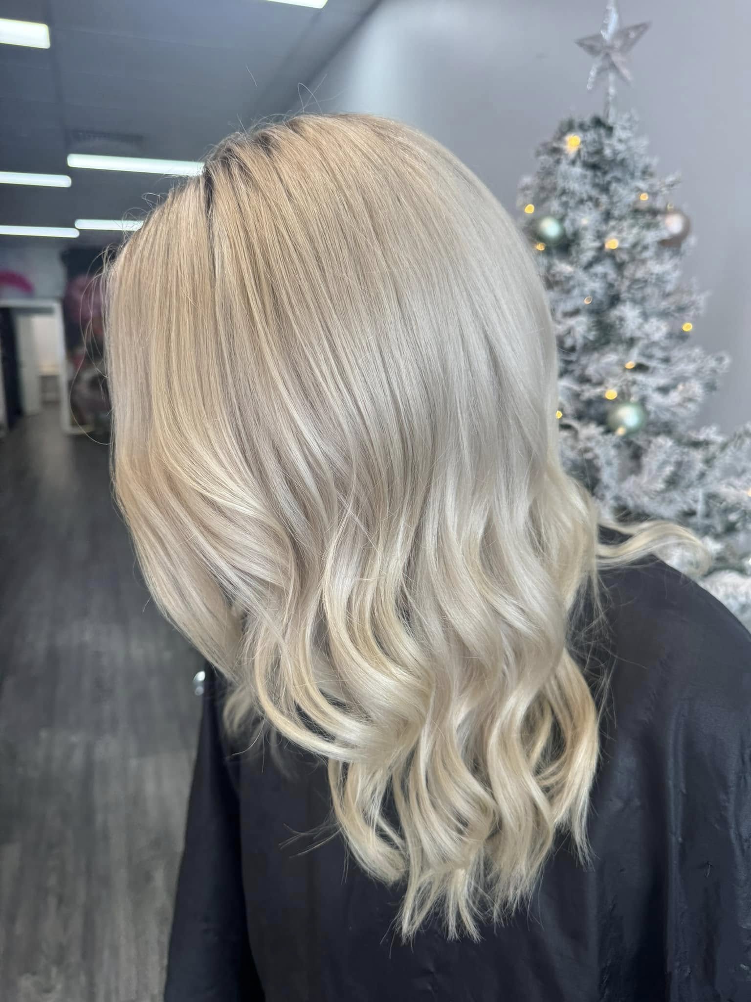 Soft blonde balayage with waves by Rosewood in Woonona