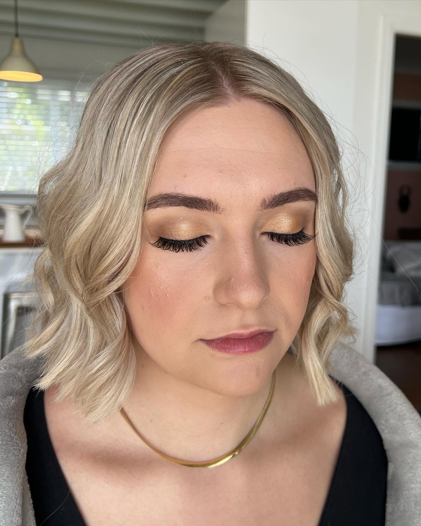 Gold-toned glam eye makeup with lashes by Rosewood in Woonona